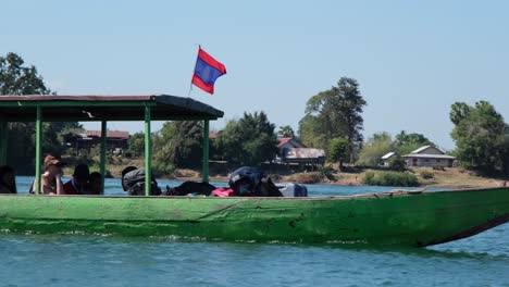 Tourists-aboard-a-speeding-boat-journey-along-the-Mekong-River-within-the-4000-Islands,-experiencing-adventure-and-exploration-amidst-the-serene-waters-and-lush-surroundings