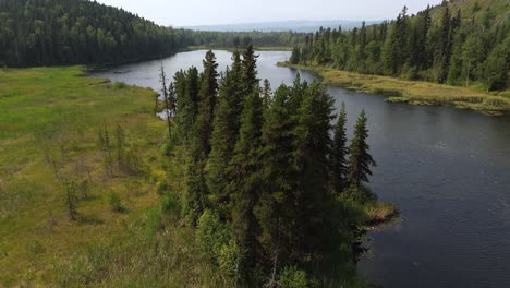 Pedestal-Aerial-Drone-Shot-Rising-Up-Revealing-Views-of-Seeley-Lake-Provincial-Park-with-Beautiful-Alpine-Trees-Covering-the-Landscape,-Smithers,-Canada