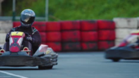 Conductores-De-Karts-Que-Salen-De-Turno-Manteniendo-La-Velocidad-En-La-Línea-De-Carrera-Ideal