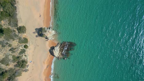 transparent-turquoise-blue-water-caribbean-Serene-drone-footage-showcases-the-breathtaking-scenery-of-Lloret-De-Mar-and-the-stunning-Cala-Canyelles,-jewels-of-Costa-Brava