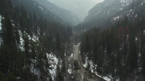 Car-Driving-Through-American-Fork-Canyon-In-Winter,-Aerial-Shot