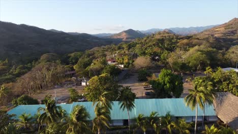 Aerial-drone-shot-of-a-resort-in-El-Salvador-with-palm-trees-and-hotel-rooms