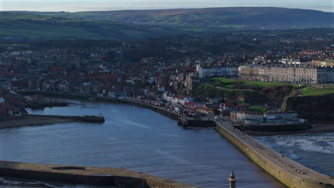 Establishing-Drone-Shot-of-Whitby-Coastal-Town-at-High-Tide-Yorkshire