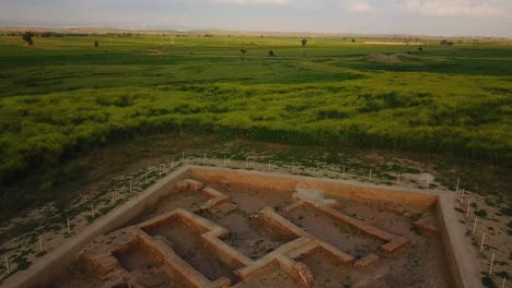 Fly-over-ancient-historical-Archaeological-site-the-ruins-of-Gundeshapur-Sassanian-empire-university-school-the-traditional-mud-plan-brick-building-in-summer-season-wonderful-lift-off-aircraft-in-iran