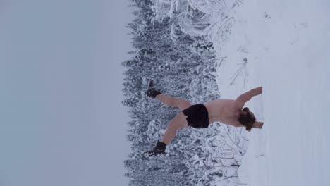 A-Man-is-Performing-a-Handstand-in-the-Midst-of-Deep-Snow---Vertical-Shot
