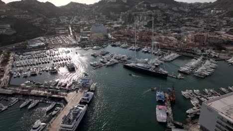 Daytime-view-of-the-marina-in-Cabo-San-Lucas-Mexico,-establishing-aerial-fly-over