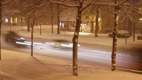 Timelapse-of-street-traffic-on-snowy-winter-night-in-Stockholm,-Sweden