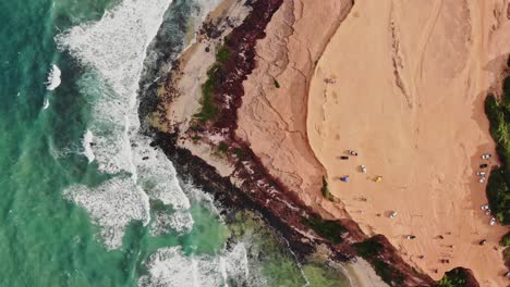 Top-Down-View-Over-the-Chapadao-de-Pipas-in-Mexico-with-Ocean-Waves-and-Tourists-Visiting