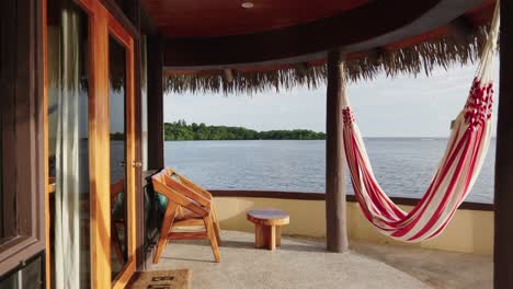 Slow-cinematic-slider-video-of-luxury-overwater-bungalow-in-Fiji-looking-across-the-ocean-at-sunset