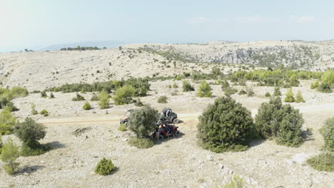 Young-Tourists-on-Dune-Buggies-Lost-in-the-Middle-of-Large-Desert-Island,-Aerial-View