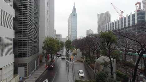 View-of-the-car-moving-to-the-underground-car-park-on-the-rainy-day-with-the-train-in-the-background