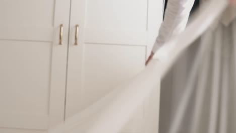 Bride-being-helped-with-laying-her-wedding-dress-correctly-on-the-floor