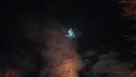 Moon-and-sky-over-a-large-outdoors-fire