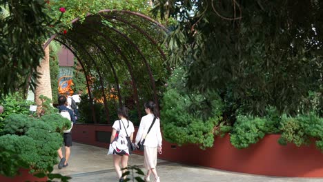 People-visiting-the-landmark-attraction,-world-largest-glass-greenhouse-Flower-Dome-at-Gardens-by-the-bay-with-variety-of-flowers-and-plants-display-in-the-conservatory,-static-shot