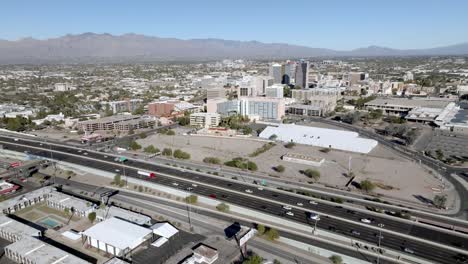 Interstate-10-and-Tuscon,-Arizona-skyline-with-drone-video-moving-in-a-circle