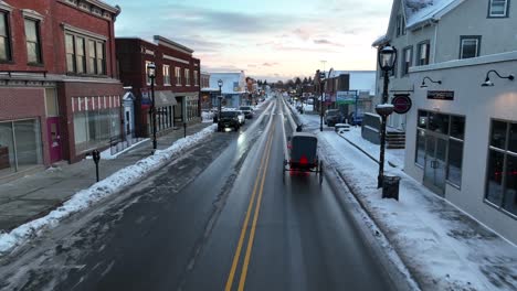 Aerial-shot-of-an-Amish-horse-and-buggy-on-a-road