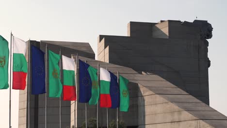 Row-of-European-flags-outside-Bulgarian-State-Monument-in-Shumen-on-windy-day