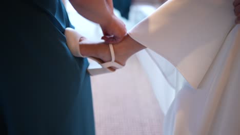 Experience-delicate-hands-securing-the-bride's-final-touch—a-timeless-tradition-symbolizing-trust,-support,-and-endless-love