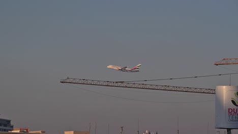 An-Emirates-airline-flight-begins-its-journey-after-taking-off-from-Dubai-International-Airport,-United-Arab-Emirates,-soaring-into-the-skies-on-its-route-to-its-destination