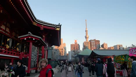 Walking-around-temple-grounds-of-Senso-ji-Shrine-in-Asakusa-with-Tokyo-Skytree-as-backdrop