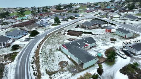 Aerial-view-of-Whidbey-Island-neighborhood-covered-in-snow