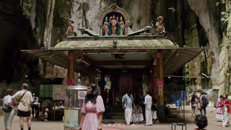 Woman-in-pink-poses-at-Batu-Caves'-temple-entrance