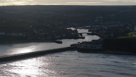 Wide-Angle-Establishing-Aerial-Shot-of-Whitby-Coastal-Town-at-High-Tide