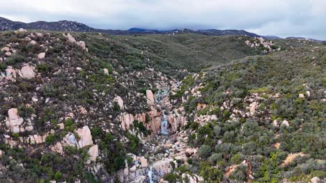 Aerial-View-of-Waterfall-with-graffiti-and-tagged-rocks-around-it