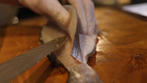 Chef-Skilfully-Slicing-And-Filleting-Fish-On-Cutting-Board