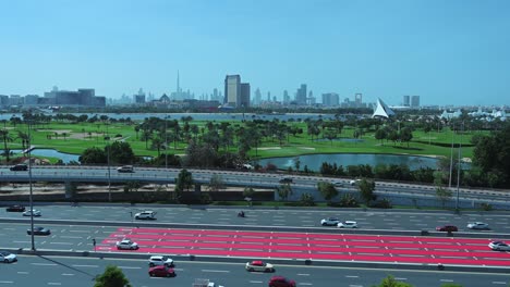 Dubai-skyline-view-from-Deira-as-traffic-flows-on-the-Airport-Road-in-Dubai,-United-Arab-Emirates