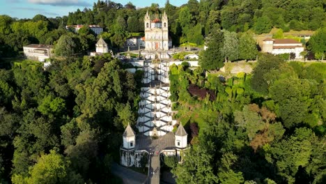 Aerial-View-of-Bom-Jesus-Stairclimb-in-Braga,-Northern-Portugal,-with-Two-Joggers-climbing-towards-Sanctuary