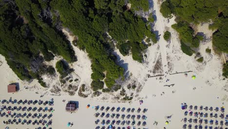 Drone-panning-overhead-revealing-the-sandy-beachfront-of-Cala-Agulla,-located-in-Llevant-Peninsula-on-the-island-of-Mallorca,-Spain