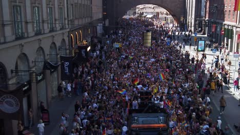 Celebrators-with-rainbow-flags-at-the-Stockholm-Pride-Parade,-seen-from-above