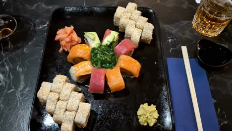 Delicious-sushi-plate-on-restaurant-table,-top-down