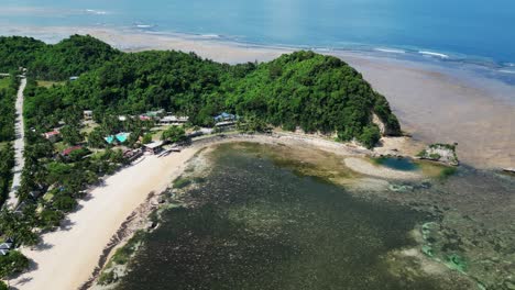 Idyllic-aerial-view-of-Philippine-island-tropical-resort-and-cove-during-low-tide-on-a-summer-day