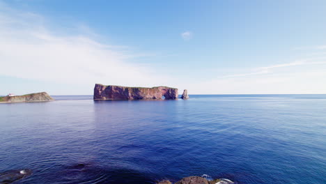 Aerial-drone-view-of-Percé-Rock-above-the-Saint-Lawrence-River-during-a-sunny-day