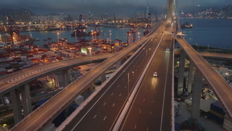 Traffic-on-Chinese-Stonecutter-bridge-over-illuminated-Container-Port-in-Hong-Kong