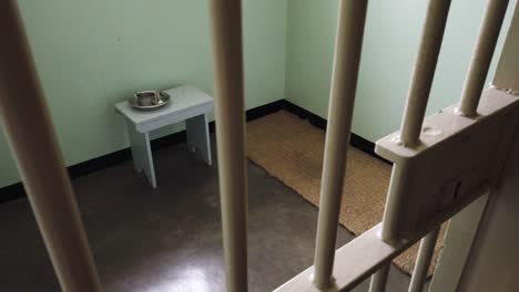 Prison-cell-at-Robben-Island-seen-through-bars