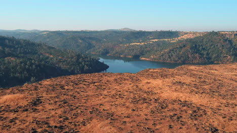 Aerial-Reveal-Of-Lake-Tulloch-And-O’Byrnes-Ferry-Bridge-From-Cliff-In-Copperopolis,-California