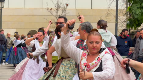 Many-couples-dressed-in-typical-clothing-known-as-huertanas-in-Valencia,-Spain-dancing-to-the-rhythm-of-music-at-las-fallas-festival