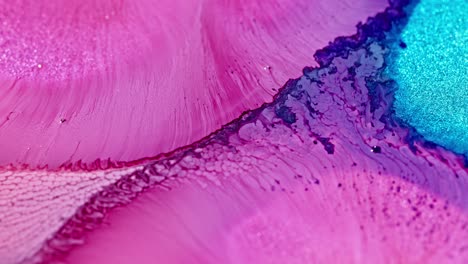 Macro-shot-of-vibrant-pink-and-blue-ink-diffusing-in-water,-creating-an-abstract-art-effect