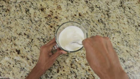 Mixing-homemade-sauce-with-mayonnaise,-top-down-establisher