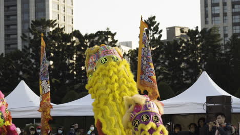 Lion-dance-performers-surround-Dragon-chasing-pearl-at-Chiang-Kai-shek-Memorial,-Taipei-Taiwan