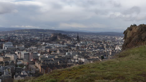 View-of-City-of-Edinburgh-skyline-from-Arthur's-Seat-Crags-with-Edinburgh-Castle-below,-Scotland