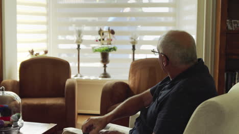 Elderly-retired-man-greeting-friend-outside-and-unlocks-front-door-using-remote