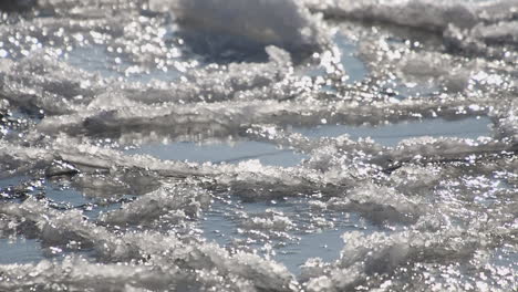 Narrow-focus-closeup:-Ice-pans-on-Baltic-Sea-bump-in-gentle-waves