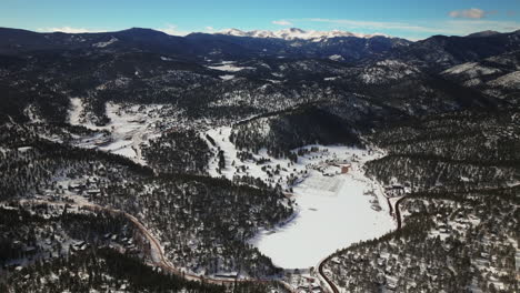 Evergreen-Colorado-aerial-drone-downtown-high-altitude-incredible-scenic-view-of-Mount-Evans-Bluesky-three-sisters-lake-house-golf-course-high-school-winter-sunny-morning-Denver-open-space-circle-left