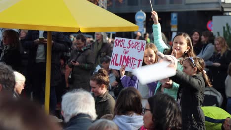 Young-girls-with-signs-chanting-at-climate-rally-in-Stockholm,-Sweden