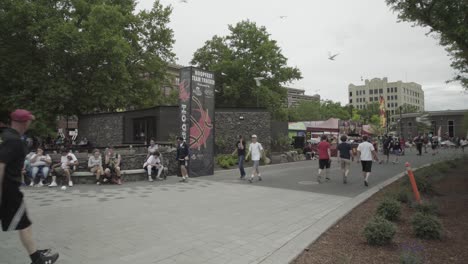 Hoopfest-2018---wide-shot-of-crowd-walking-past-Hoopfest-sign-in-the-background