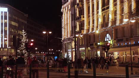 People-move-around-under-Christmas-lights-at-Stureplan-in-Stockholm